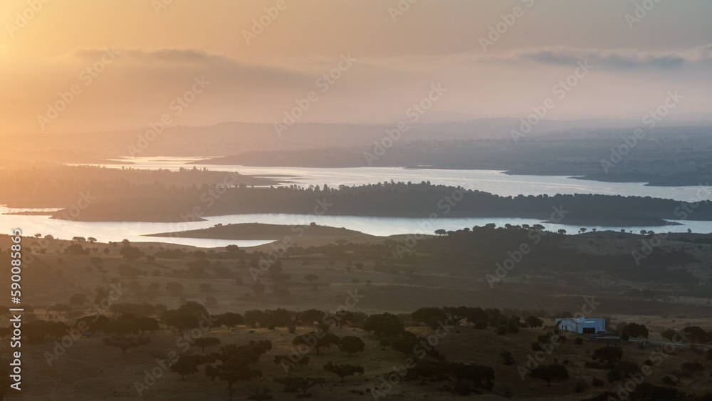 Portugal, Monsaraz, Alentejo. View from the fortress walls to Guadiana river and shores at a foggy dawn