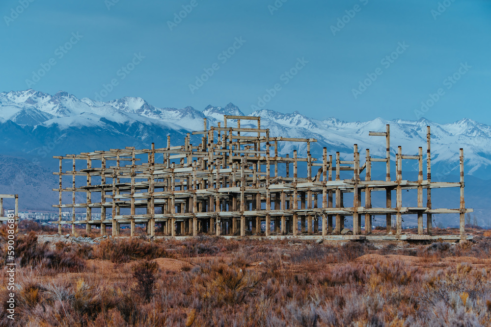 Abandoned concrete building on mountains background