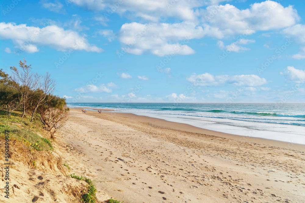 Amazing wide panoramic view of the ocean with hypnotic waves rolling onto the pristine sandy beach during stunning sunrise. Amazing wide panoramic view of the ocean with hypnotic waves rolling onto the pristine sandy beach during stunning sunrise.
