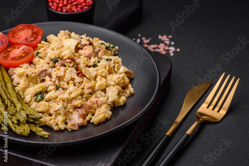Delicious scramble with salmon, sun-dried tomatoes, spinach, spices and herbs