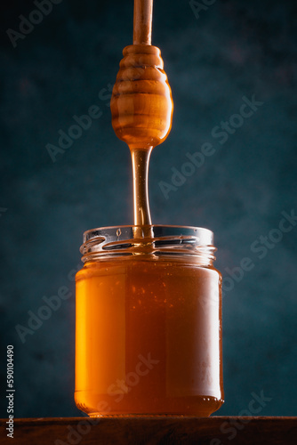 Jar of honey and honey spoon