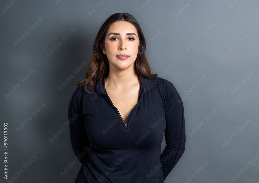 portrait of serious hispanic young woman looking at camera portrait of serious hispanic young woman looking at camera