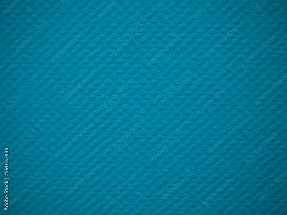 Textured background of a plasterboard wall that has been wallpapered for painting and painted blue. Wallpaper for painting with a beautiful blue texture. Background, close-up. Textured background of a plasterboard wall that has been wallpapered for painting and painted blue. Wallpaper for painting with a beautiful blue texture. Background, close-up.