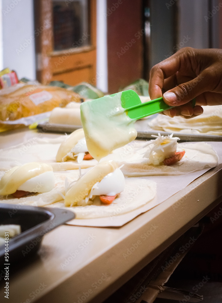 person preparing food in kitchen person preparing food in kitchen