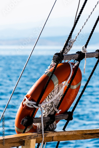 Orange lifeline ring on a boat. Lifebuoy ring.