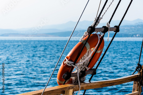 Orange lifeline ring on a boat. Lifebuoy ring. © Sulugiuc