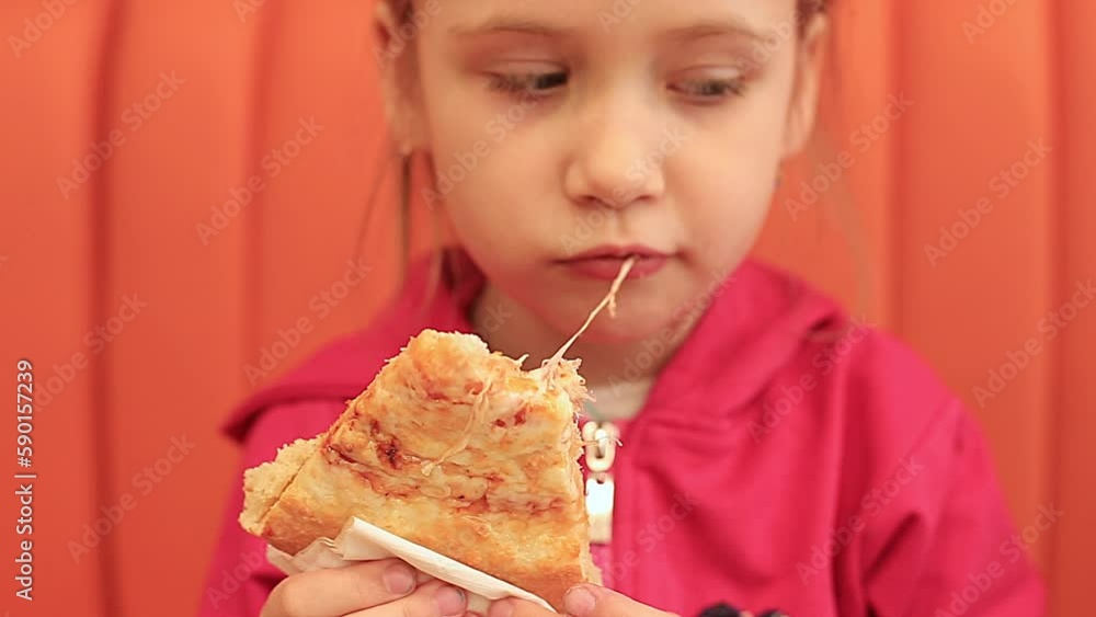 Cute Girl Eating Pizza at the orange sofa Cute Girl Eating Pizza at the orange sofa