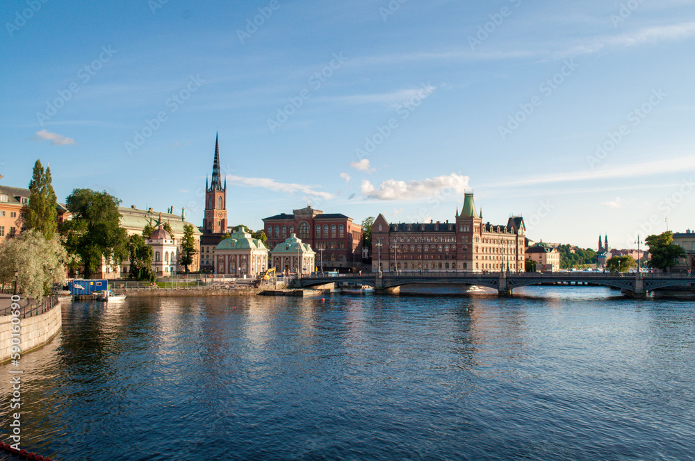 Stockholm, Sweden - July 20, 2015: The capital of Sweden, sea canal embankment with old town and brick church tower.