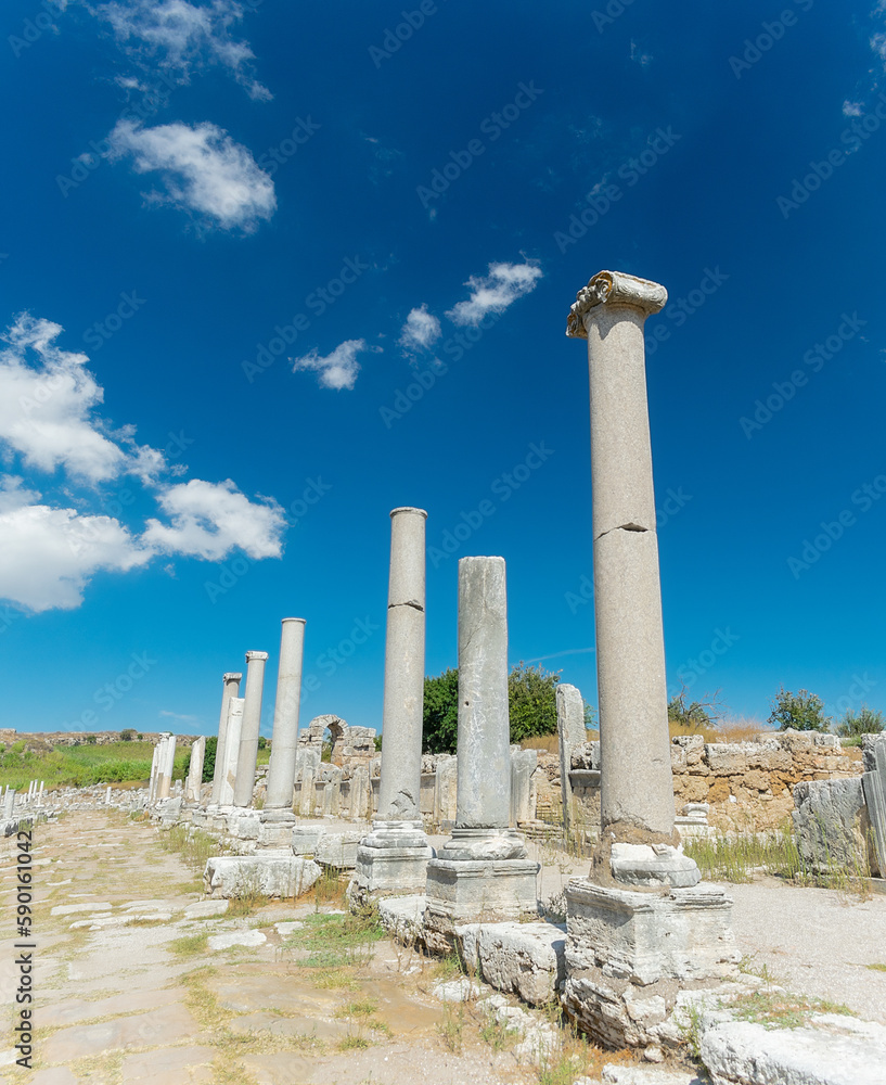 Street with columns in the ancient city of Perge. Ruins of the ancient city.