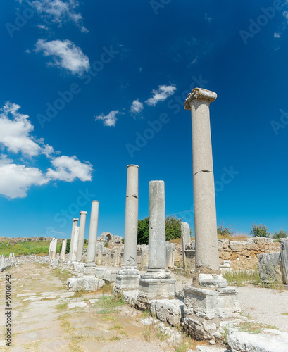 Street with columns in the ancient city of Perge. Ruins of the ancient city.