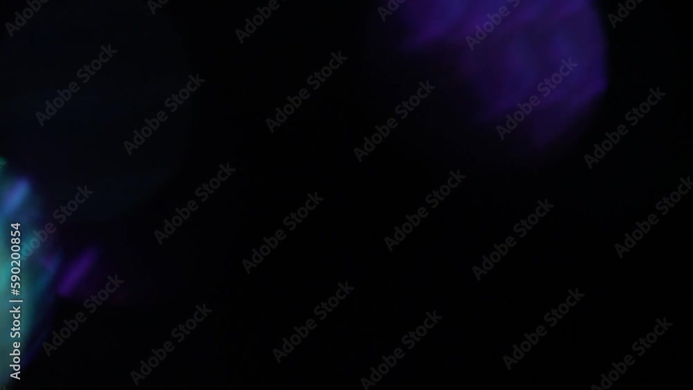 Shimmering Electric Bokeh Transition. Mint, blue and purple bokeh circles fading motion on black. Defocused circles in motion. Abstract Bokeh Background. Shimmering Electric Bokeh Transition. Mint, blue and purple bokeh circles fading motion on black. Defocused circles in motion. Abstract Bokeh Background.