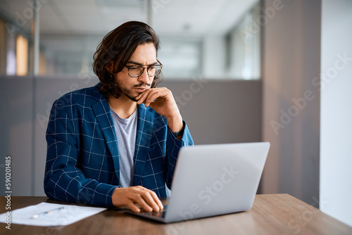 Canvas Print Distraught entrepreneur working on computer at office desk.