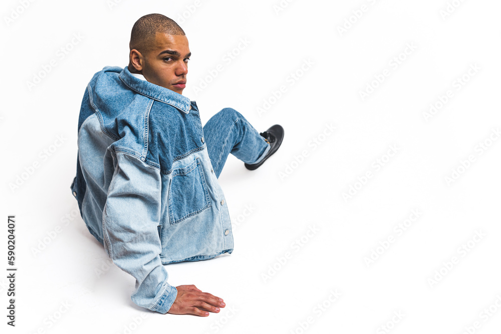 Full-length shot of young adult Black male model posing on a white studio floor in all denim suit. Copy space. High quality photo Full-length shot of young adult Black male model posing on a white studio floor in all denim suit. Copy space. High quality photo