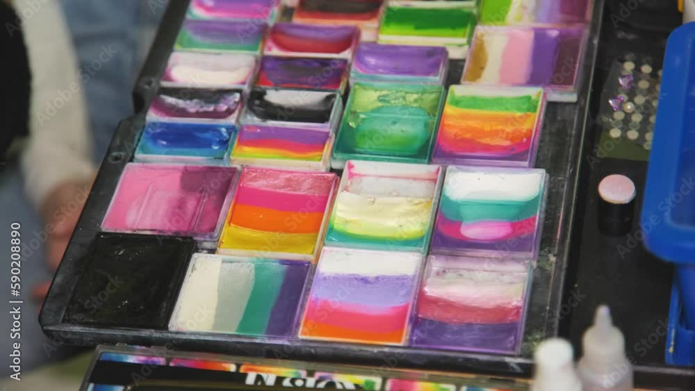 Colorful paint tubes on a table with paints used for face art. Colorful paint tubes on a table with paints used for face art.