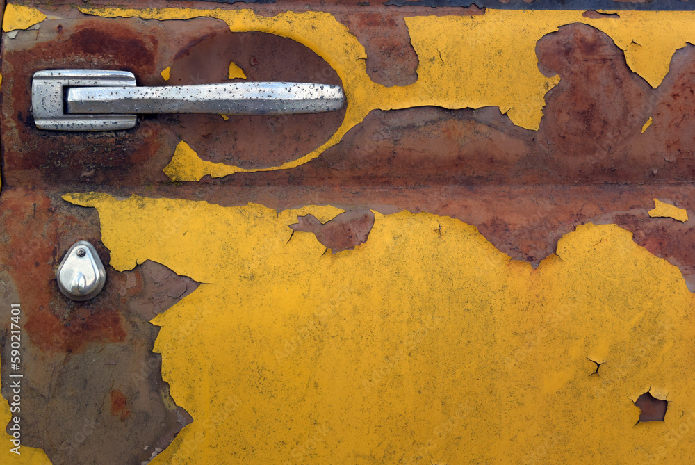 Photo of the texture of an old rusty dirty yellow car door. Car door
