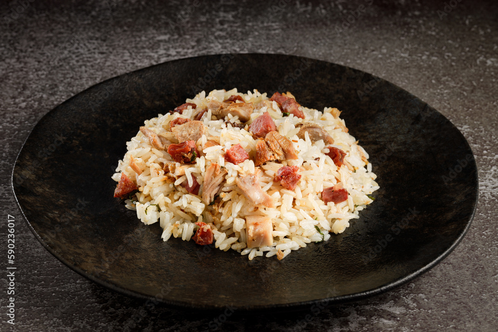 Rice dish with pieces of shank and bacon. Rice dish with pieces of shank and bacon.