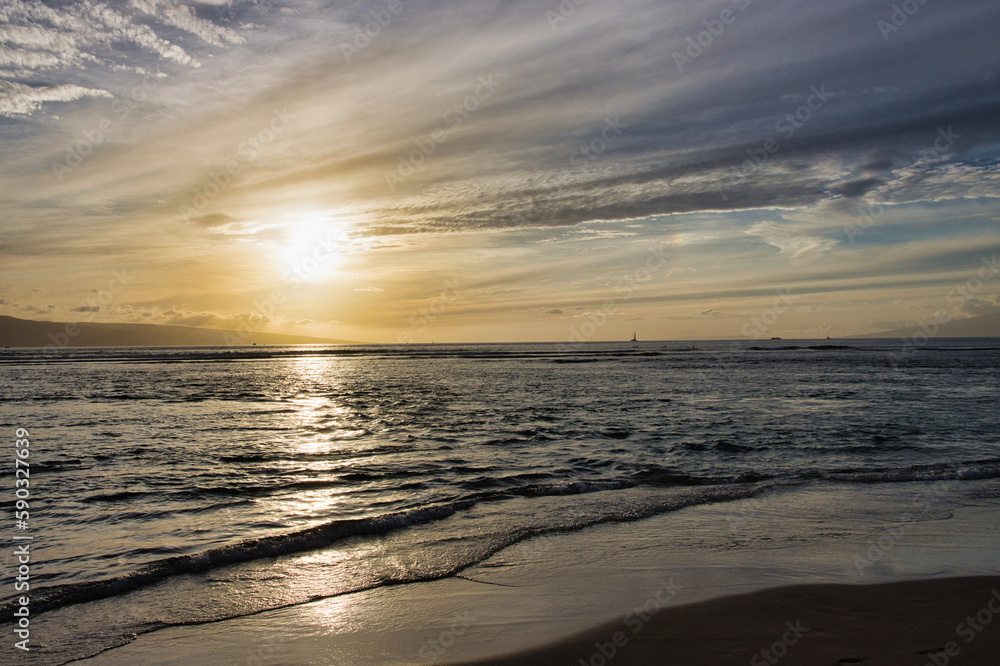 Dramatic sunset with calm ocean tide and bazing sun.