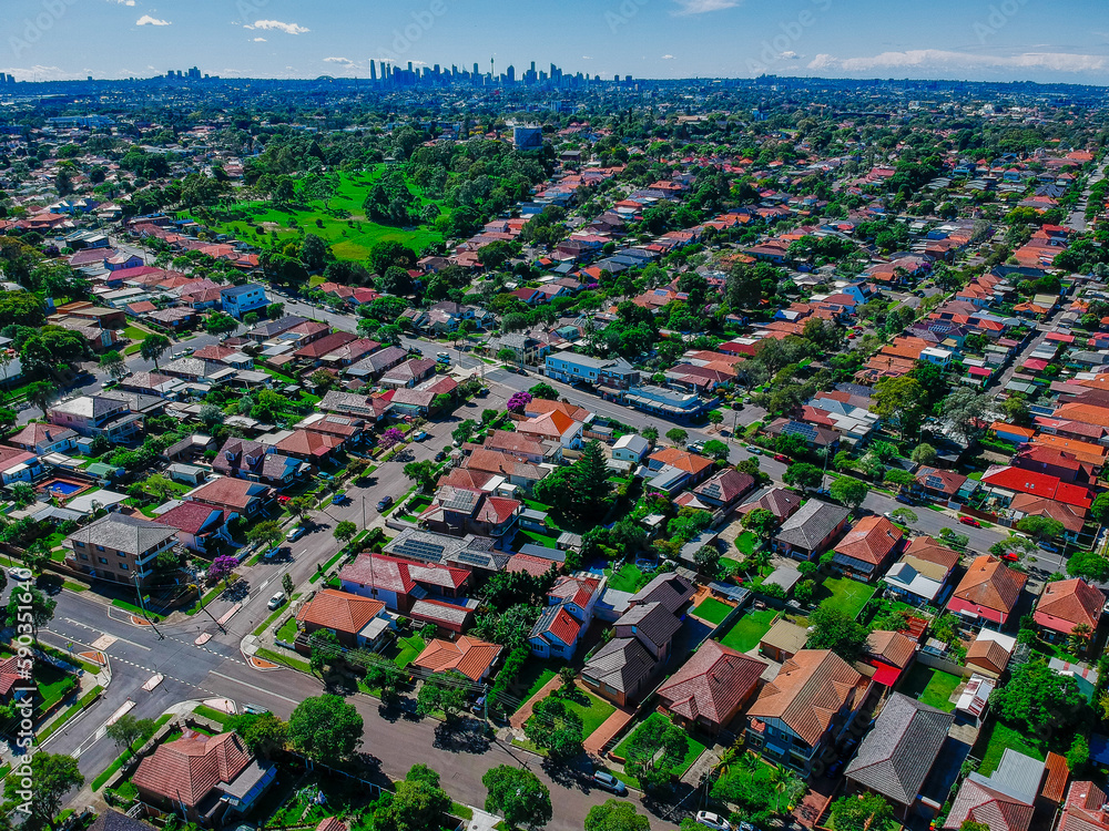 Fototapeta premium Panoramic Aerial Drone view of Suburban Sydney housing, roof tops, the streets and the parks NSW Australia