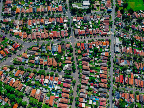 Panoramic Aerial Drone view of Suburban Sydney housing  roof tops  the streets and the parks NSW Australia