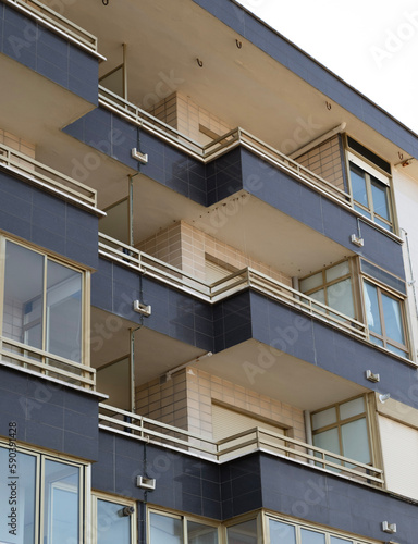 apartment building in front of the beach with blue and golden colors