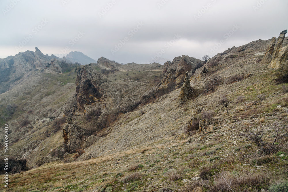 Devil's fireplace rock and bizarre rocks in Dead city. Khoba-Tele Ridge of Karadag Reserve in spring. Crimea