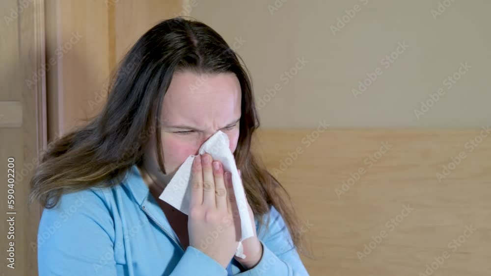 Ill allergic young woman sneezing in tissue blowing running nose. Sick girl got flu concept or caught cold, having allergy symptoms Unhealthy lady suffer from seasonal virus disease. Close up view Ill allergic young woman sneezing in tissue blowing running nose. Sick girl got flu concept or caught cold, having allergy symptoms Unhealthy lady suffer from seasonal virus disease. Close up view