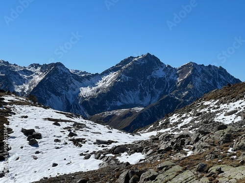 First snow on the rocky mountain peaks Leidhorn (2932 m), Bocktenhorn (3044 m) and Sattelhorn (2980 m) in the Albula Alps, Zernez - Canton of Grisons, Switzerland (Kanton Graubünden, Schweiz) photo