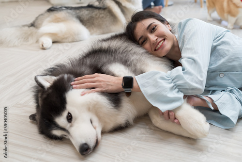 Young woman hugs her pet dog with happy and smiling at home. Young female playing having fun with cute dog. Lovely pet