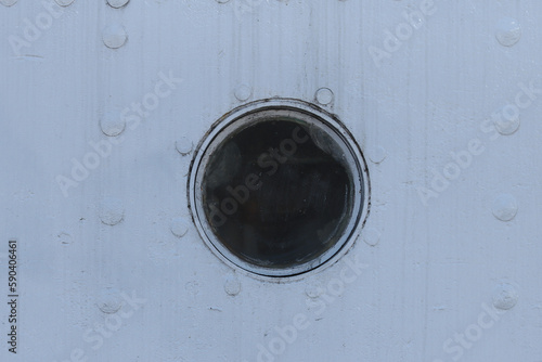 Closed porthole on a ship.