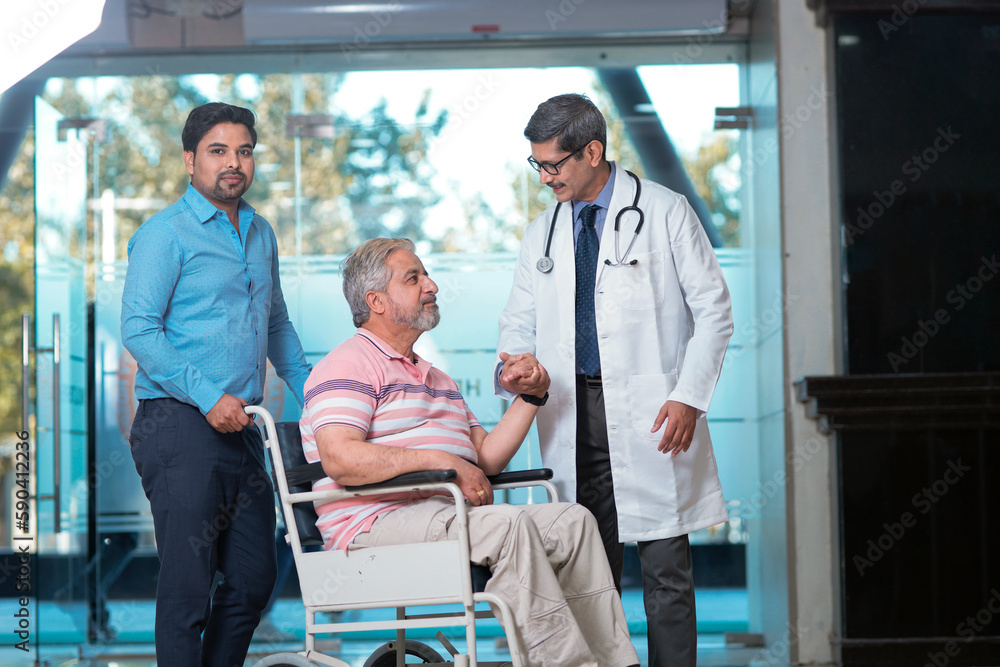 Obraz premium Doctors giving support to sick old man in a wheel chair