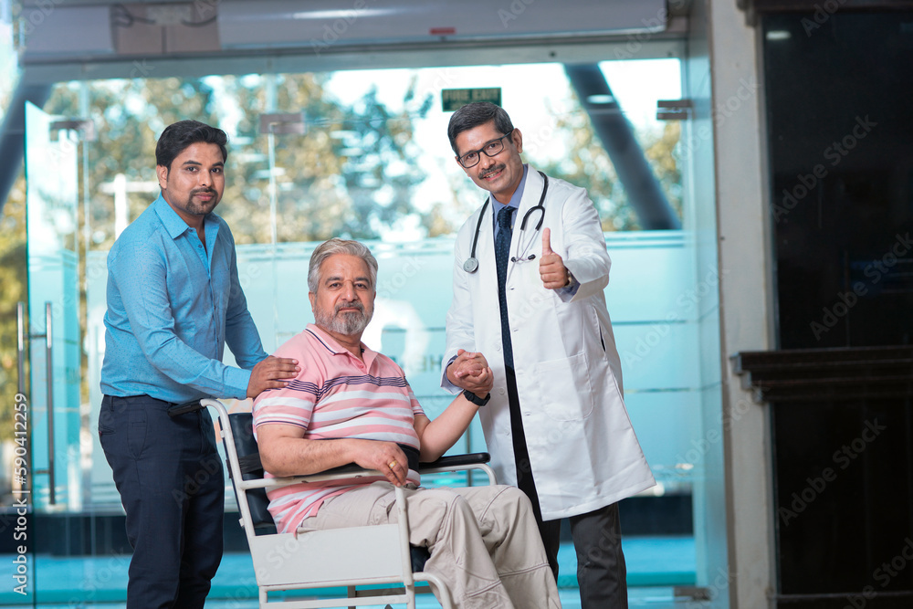 Doctors giving support to sick old man in a wheel chair Doctors giving support to sick old man in a wheel chair