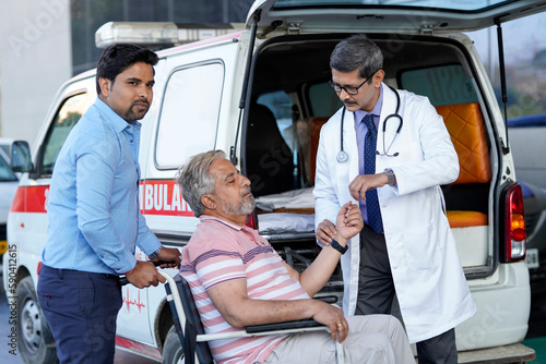 Doctor checking to old man while he is moaning in pain.