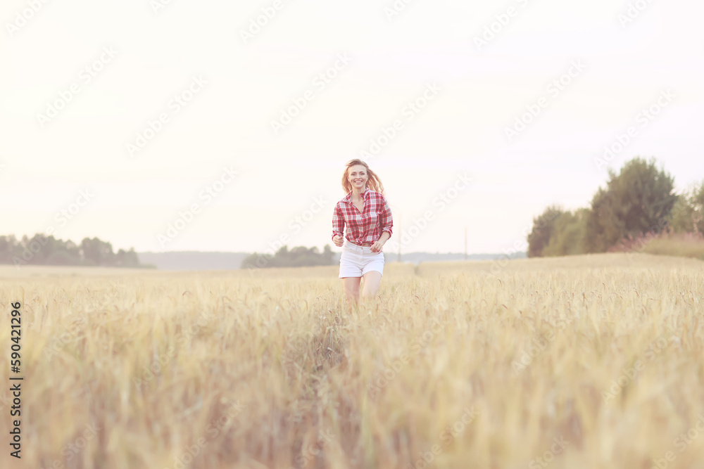girl runs through an agricultural field summer girl runs through an agricultural field summer