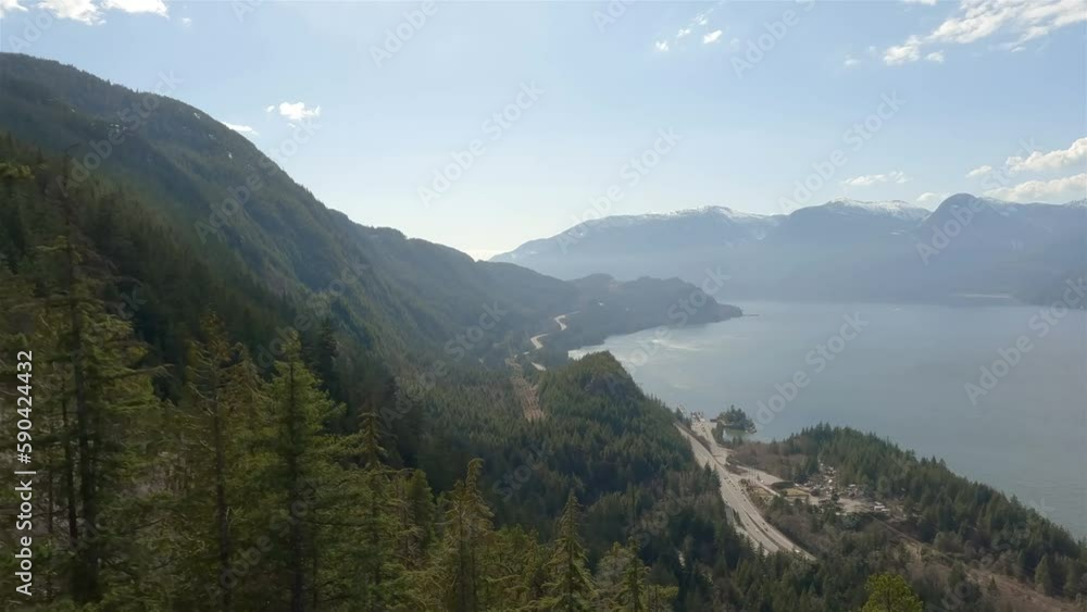 Green Trees, Canadian Mountain Landscape, Sunny Spring Season Sky. Aerial View. Squamish, British Columbia, Canada. Green Trees, Canadian Mountain Landscape, Sunny Spring Season Sky. Aerial View. Squamish, British Columbia, Canada.