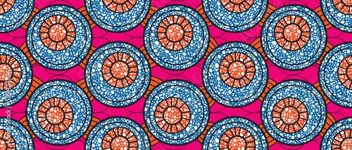 African ethnic traditional pattern. seamless beautiful Kitenge, chitenge, Ankara style. fashion design in colorful. Geometric blue circle abstract motif. pink background. African wax prints