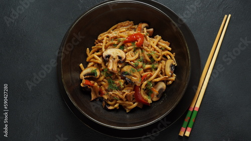 Chinese stir fried Instant noodles with mushrooms and chopsticks