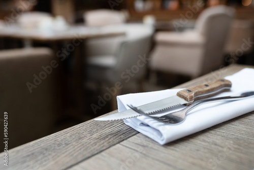 Cutlery fork and knife on a white napkin in a restaurant