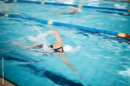 Sports  water splash or women in swimming pool for a race competition  exercise or cardio workout. Fast swimmers  freestyle stroke or healthy girl athletes racing with fitness speed or motivation