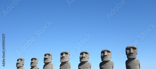 replicate easter island moai statues Ahu Akivi with clear blue sky at sun messe nichinan, miyazaki, japan front view banner