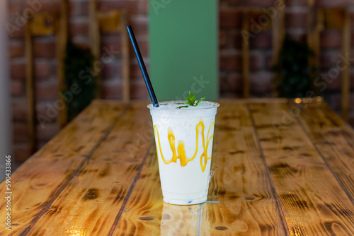 HOMEMADE MILKSHAKE IN PLASTIC WITH STRAW