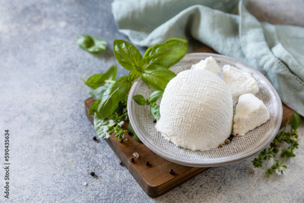 Homemade whey ricotta cheese or cottage cheese with basil ready to eat