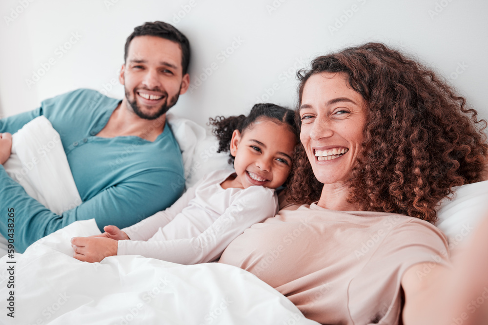 Selfie, bedroom and portrait of parents with girl in bed relax for quality time, bonding and love in morning. Family home, face and happy mother, father and child smile for picture, post and memory Selfie, bedroom and portrait of parents with girl in bed relax for quality time, bonding and love in morning. Family home, face and happy mother, father and child smile for picture, post and memory