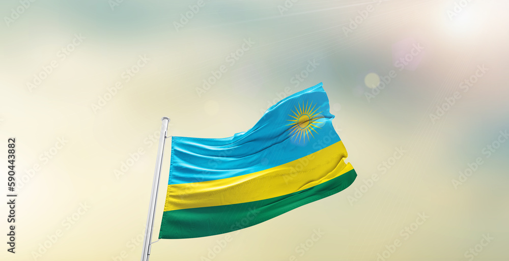 Waving Flag of Rwanda on blur sky. The symbol of the state on wavy cotton fabric.