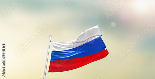 Waving Flag of Russia on blur sky. The symbol of the state on wavy cotton fabric.
