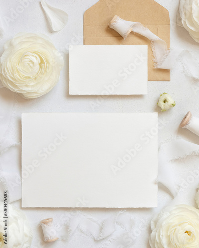 Blank cards near cream roses and white silk ribbons top view, wedding mockup