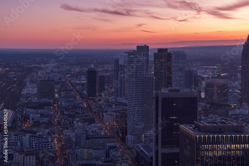 Urban centre at sunset with a pink dusk sky over the high-rises. Frankfurt at sunset with a purple-pink sky © PHAT