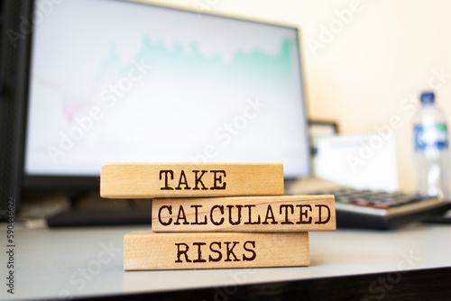 Wooden blocks with words 'Take Calculated Risks'. Business concept