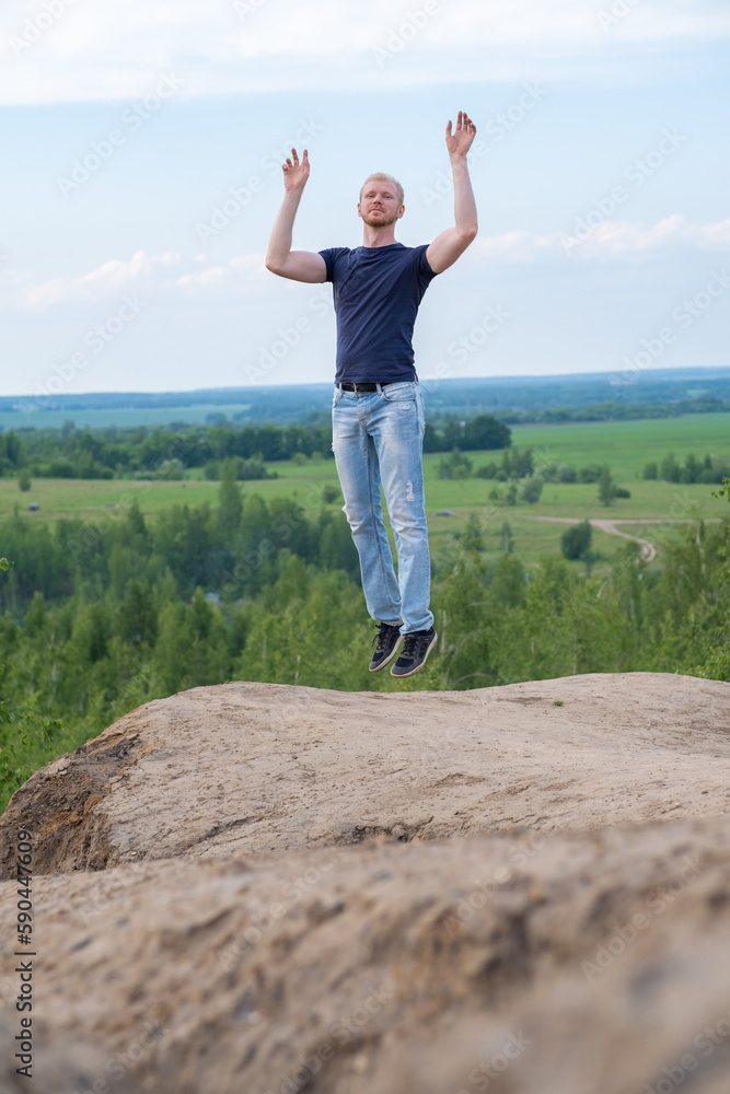A man surrounded by mountains and forests. A man in a jump A man surrounded by mountains and forests. A man in a jump