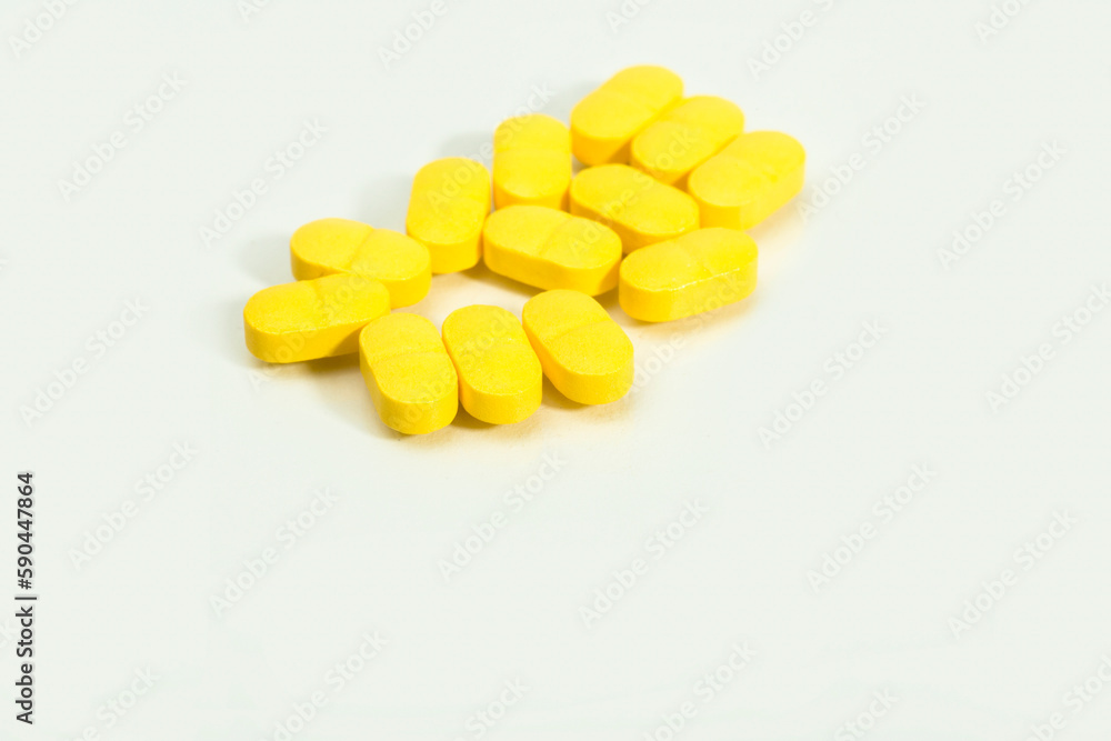 Close up shots of medicine tablets and capsules on white background. White and colored tablets placed in a group. Close up shots of medicine tablets and capsules on white background. White and colored tablets placed in a group.