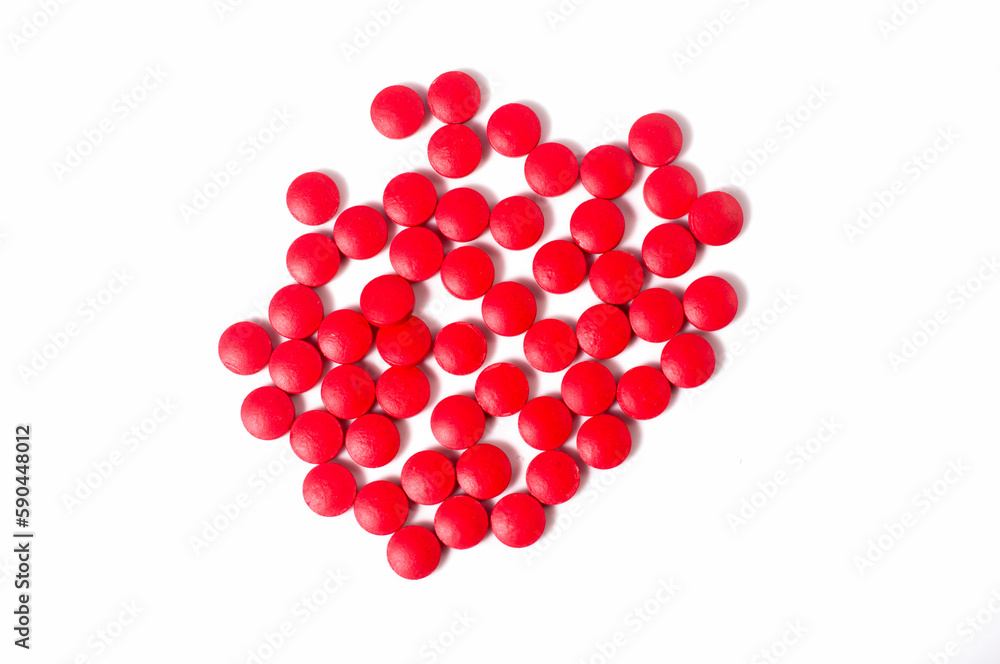 Close up shots of medicine tablets and capsules on white background. White and colored tablets placed in a group. Close up shots of medicine tablets and capsules on white background. White and colored tablets placed in a group.